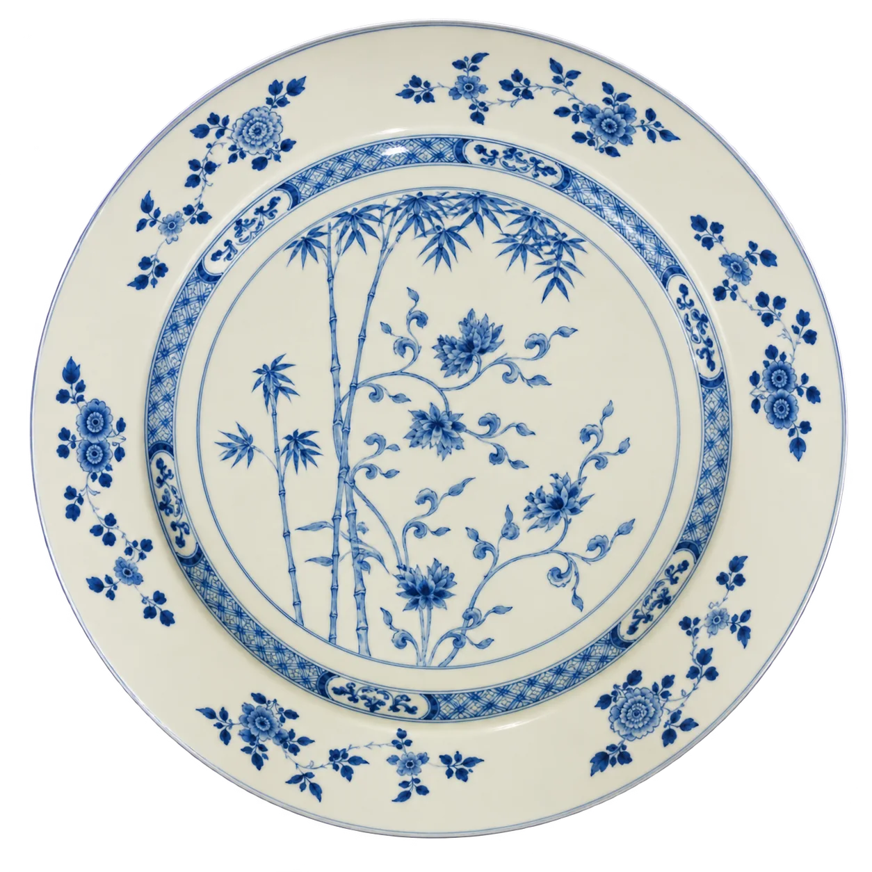 Un grand plat rond en porcelaine blanche orné de bambous et de fleurs peints en bleu, avec une bordure à motifs floraux.